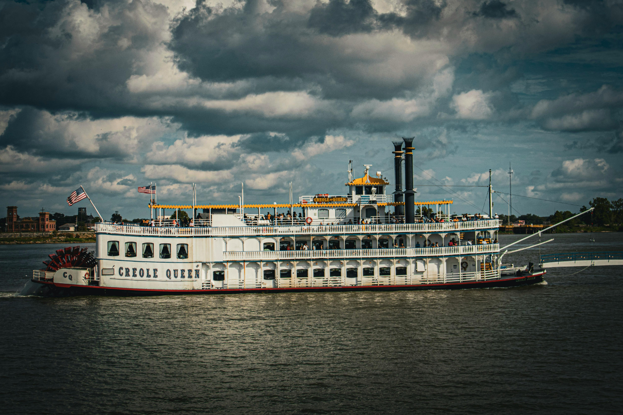 A view of an elegant steamboat, named Creole Queen, on the Mississippi River.