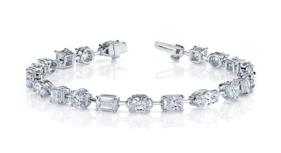 A white gold tennis bracelet from Norman Silverman with diamonds of different cuts, available at Aucoin Hart Jewelers.