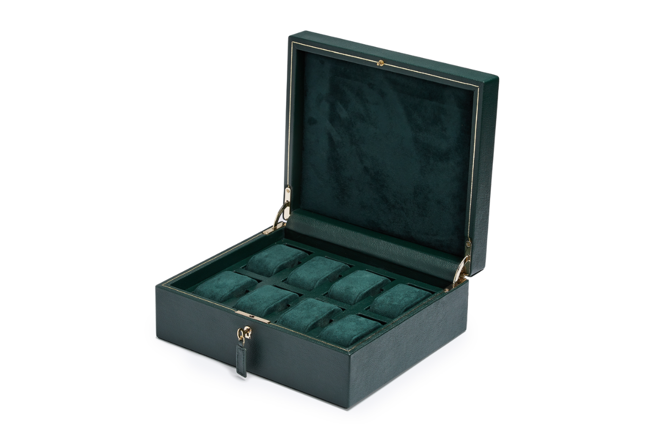 A large deep green velvet watch winder with gold accents.