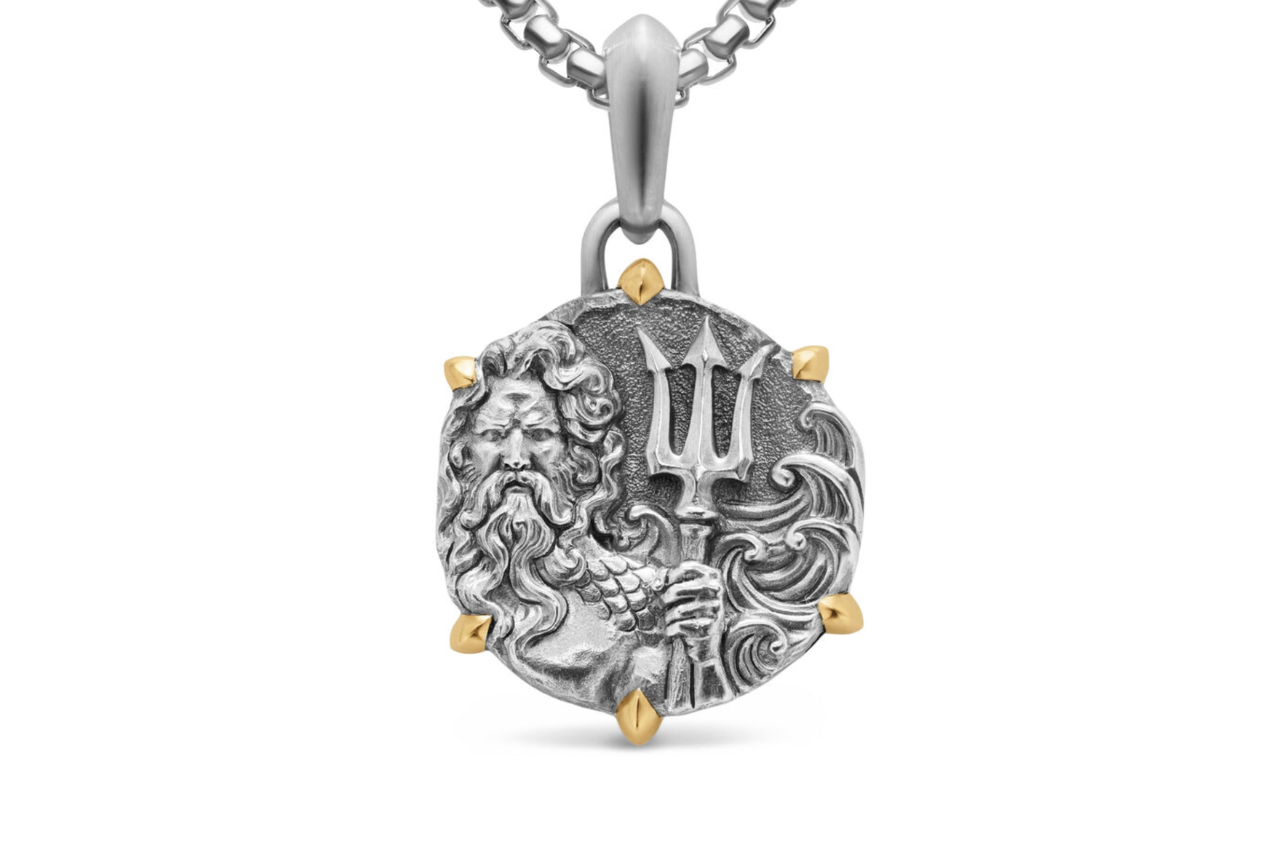 A silver amulet with Poseidon on it, gold prongs bordering it.