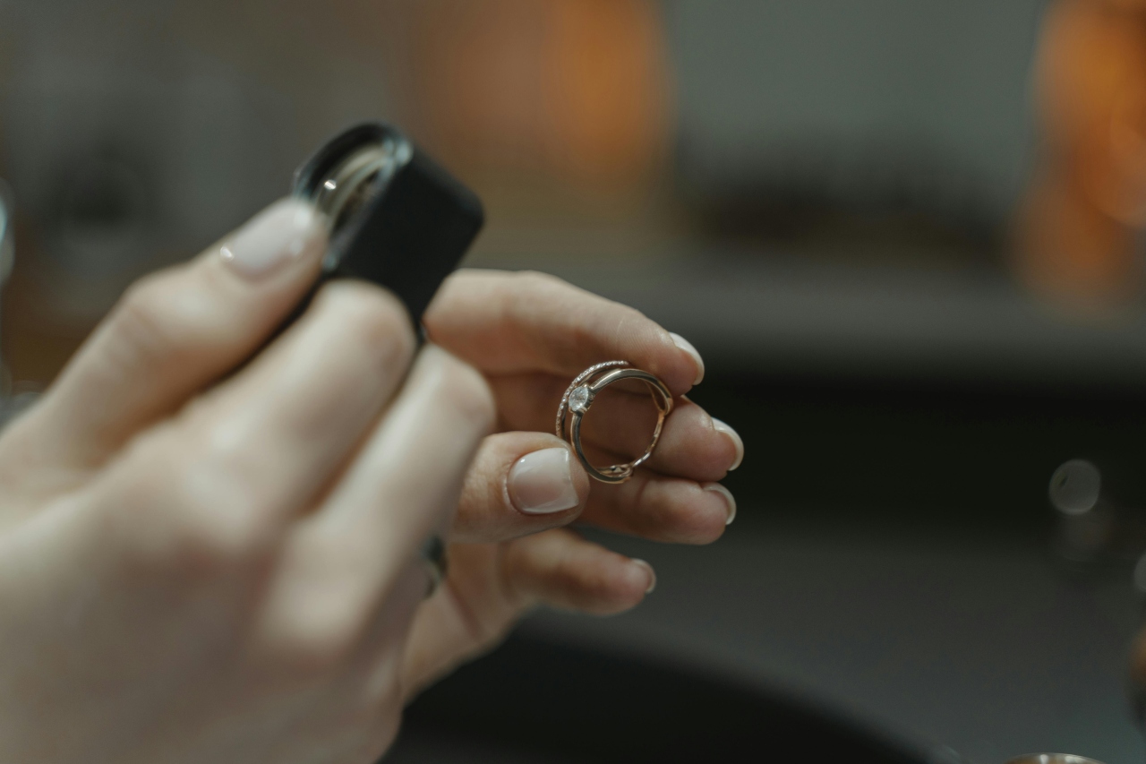 A jeweler inspecting the final product of a diamond ring
