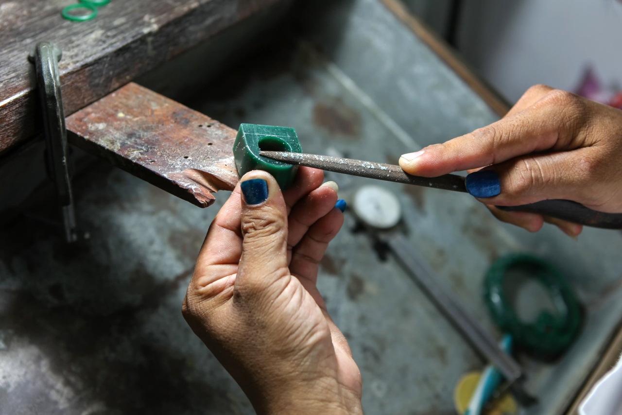 A person working on shaping a wax representation of a custom designed ring