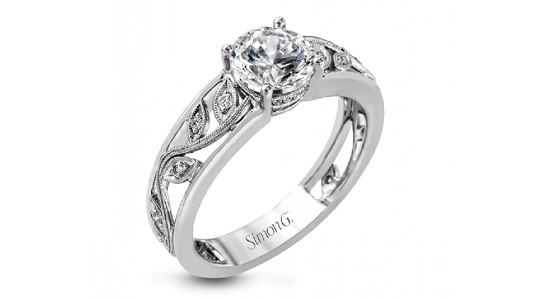 a white gold engagement ring with a thick band featuring floral details