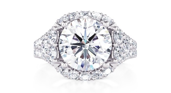 a white gold engagement ring featuring a large center stone and an elaborate silhouette
