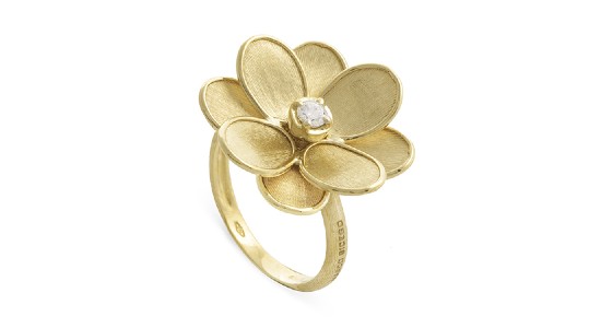 a yellow gold fashion ring by Marco Bicego in the shape of a flower with a diamond at its center