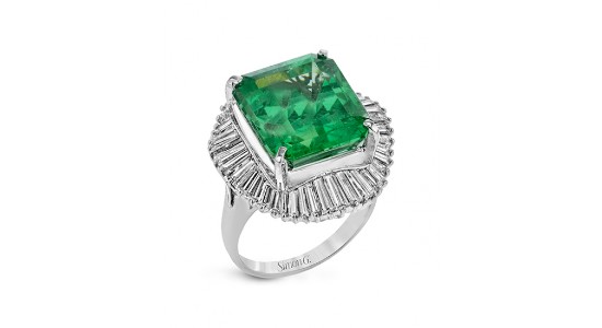 a silver statement ring by Simon G. featuring a large emerald surrounded by baguette cut diamonds