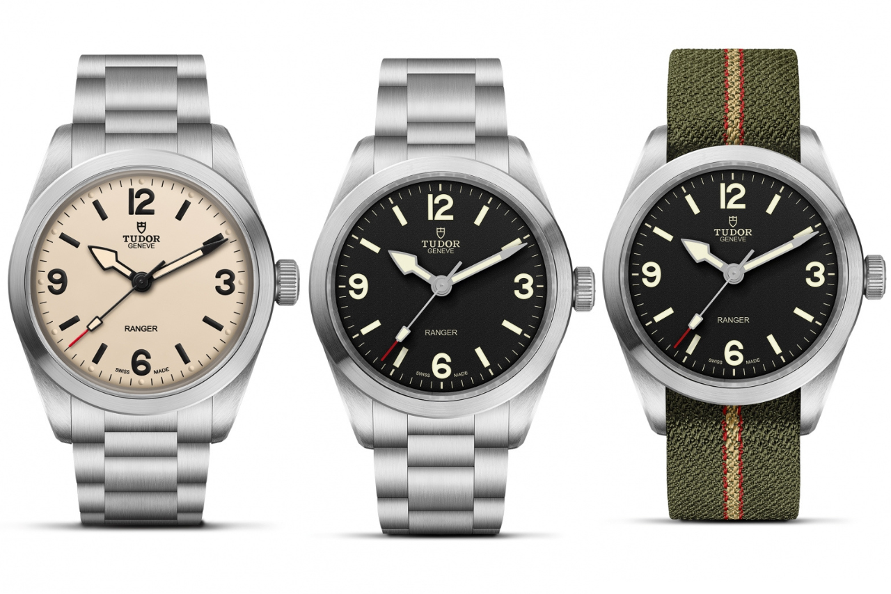 Three TUDOR watches, two with metallic bracelets, and one with a green rubber bracelet, featuring arab numerals on black and beige dials.