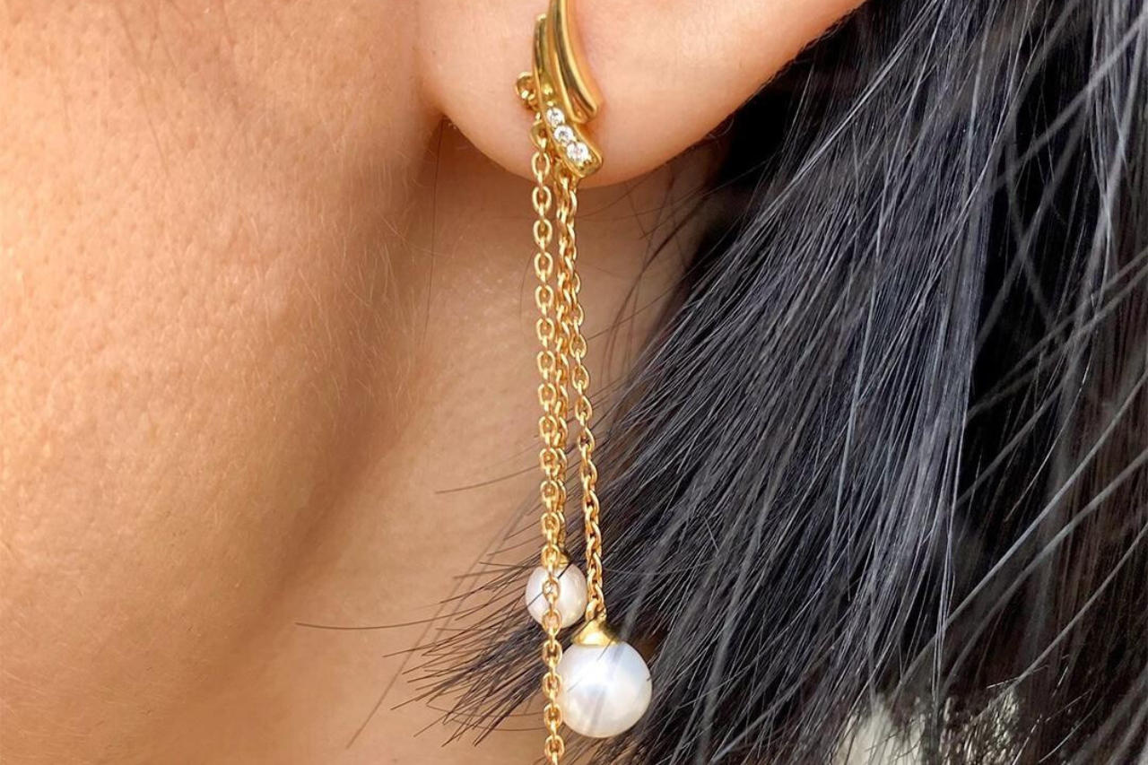 Woman standing outside with gemstone drop earrings