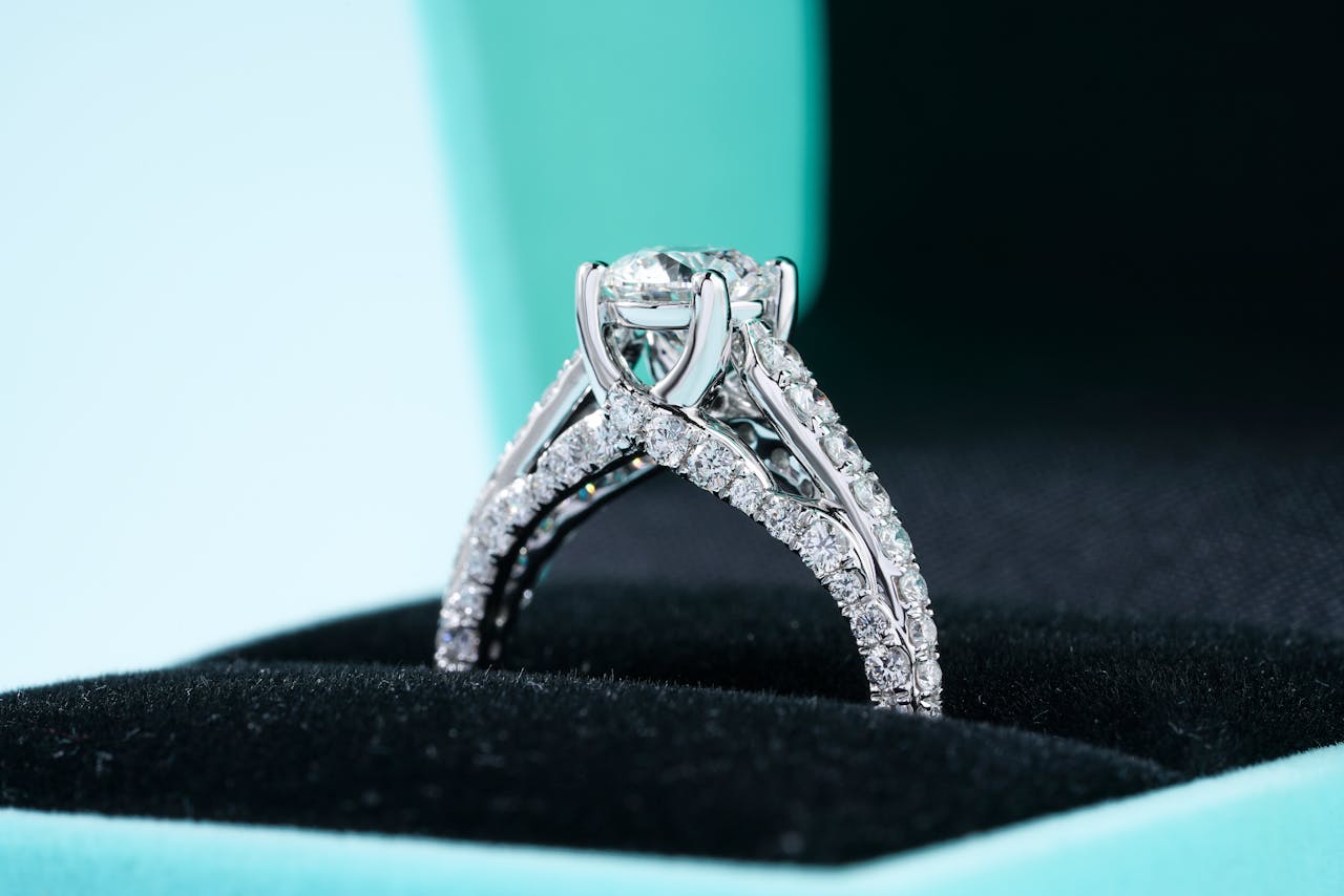 A cathedral diamond engagement ring inside a Tiffany blue velvet box. A cathedral diamond engagement ring inside a Tiffany blue velvet box.