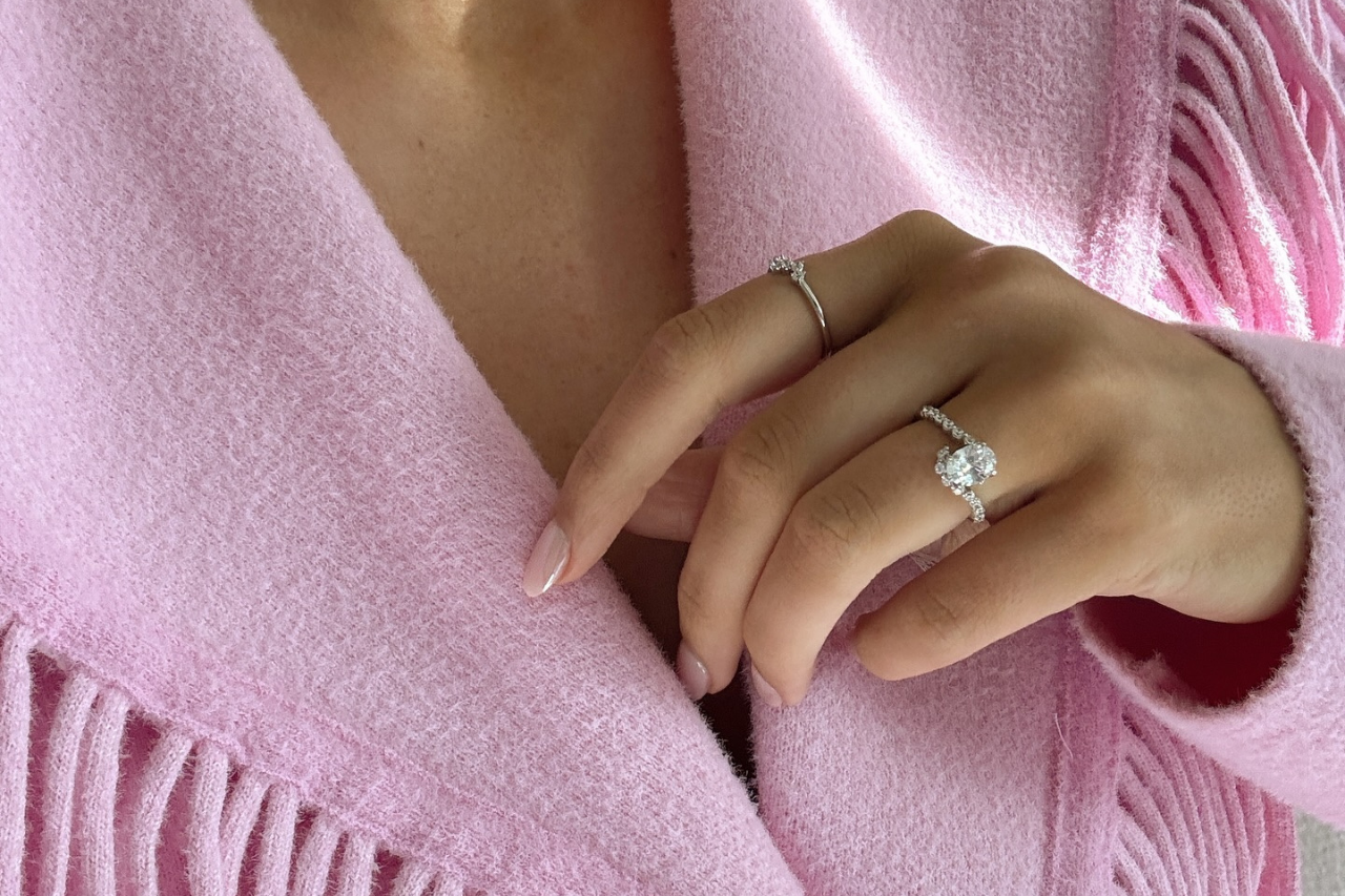 A round-cut diamond engagement ring in a rose gold setting, nestled in soft, textured fabric A round-cut diamond engagement ring in a rose gold setting, nestled in soft, textured fabric